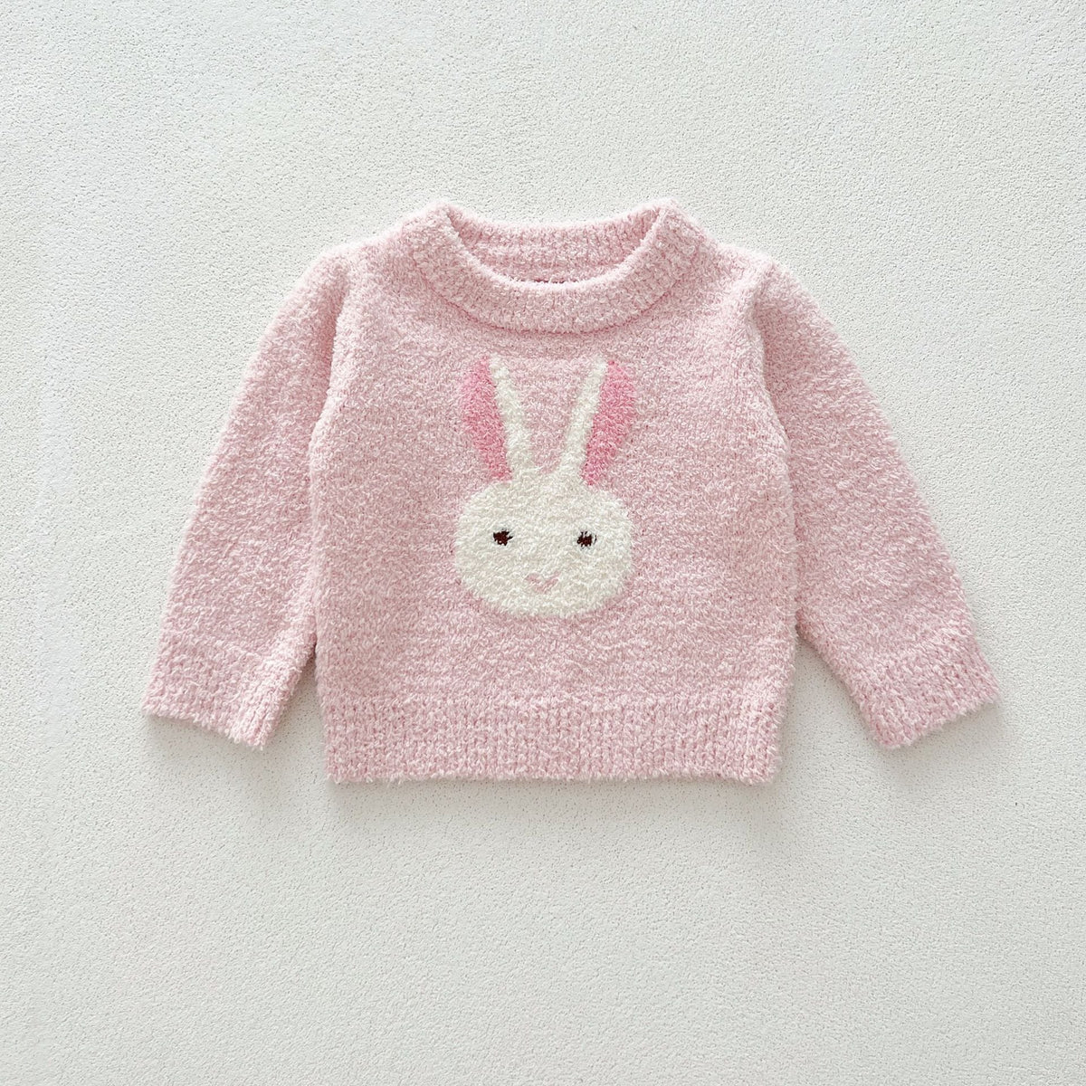 Pink fuzzy knit sweater with a bunny face