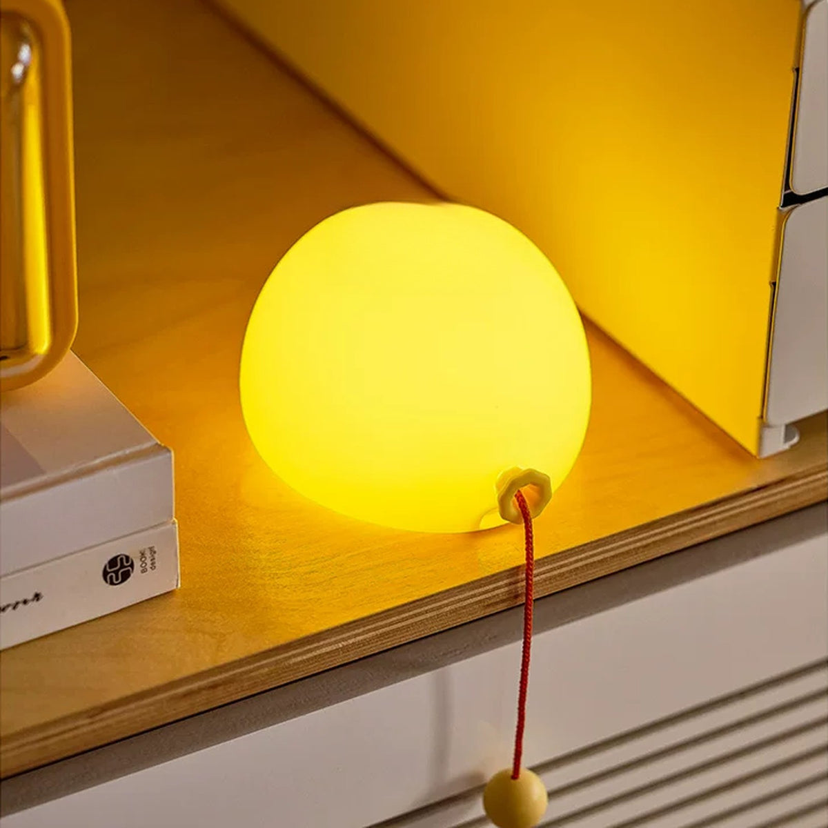 Balloon night light resting on a shelf, soft warm glow