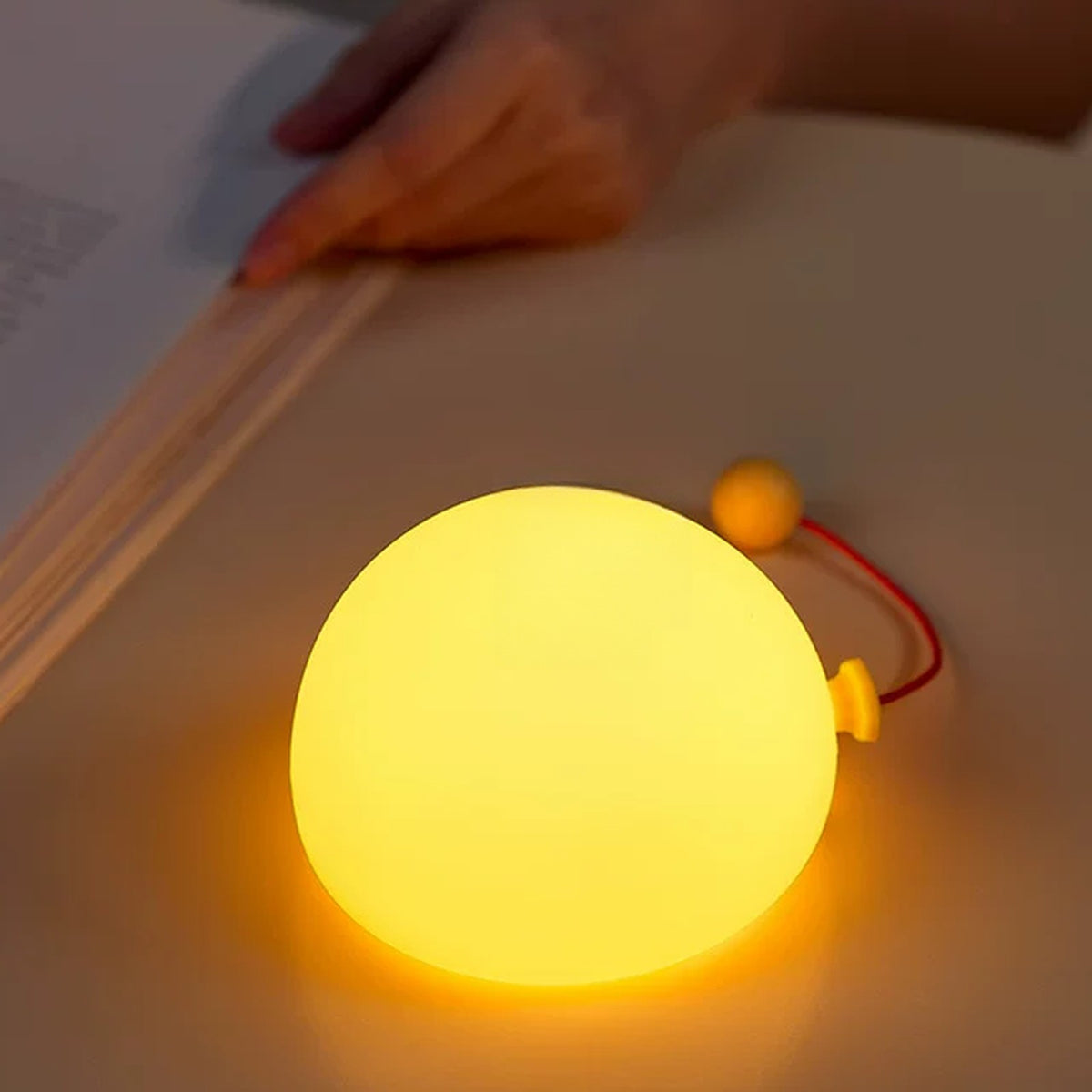 Balloon lamp glowing on a desk as a soft reading light