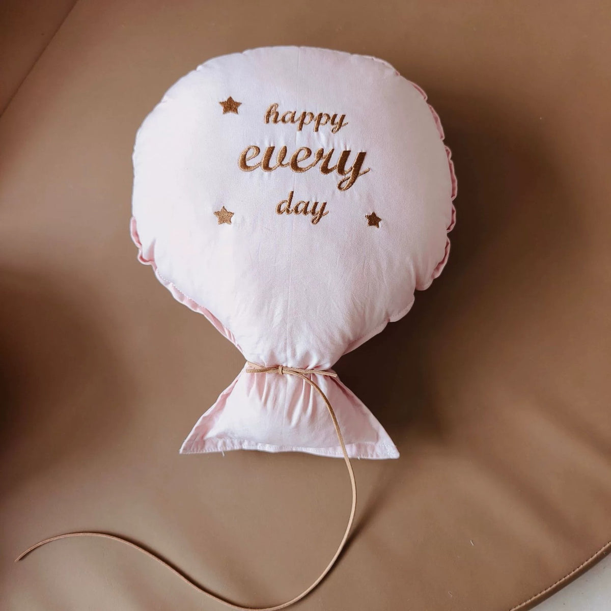 Blush pink balloon pillow embroidered "happy every day"
