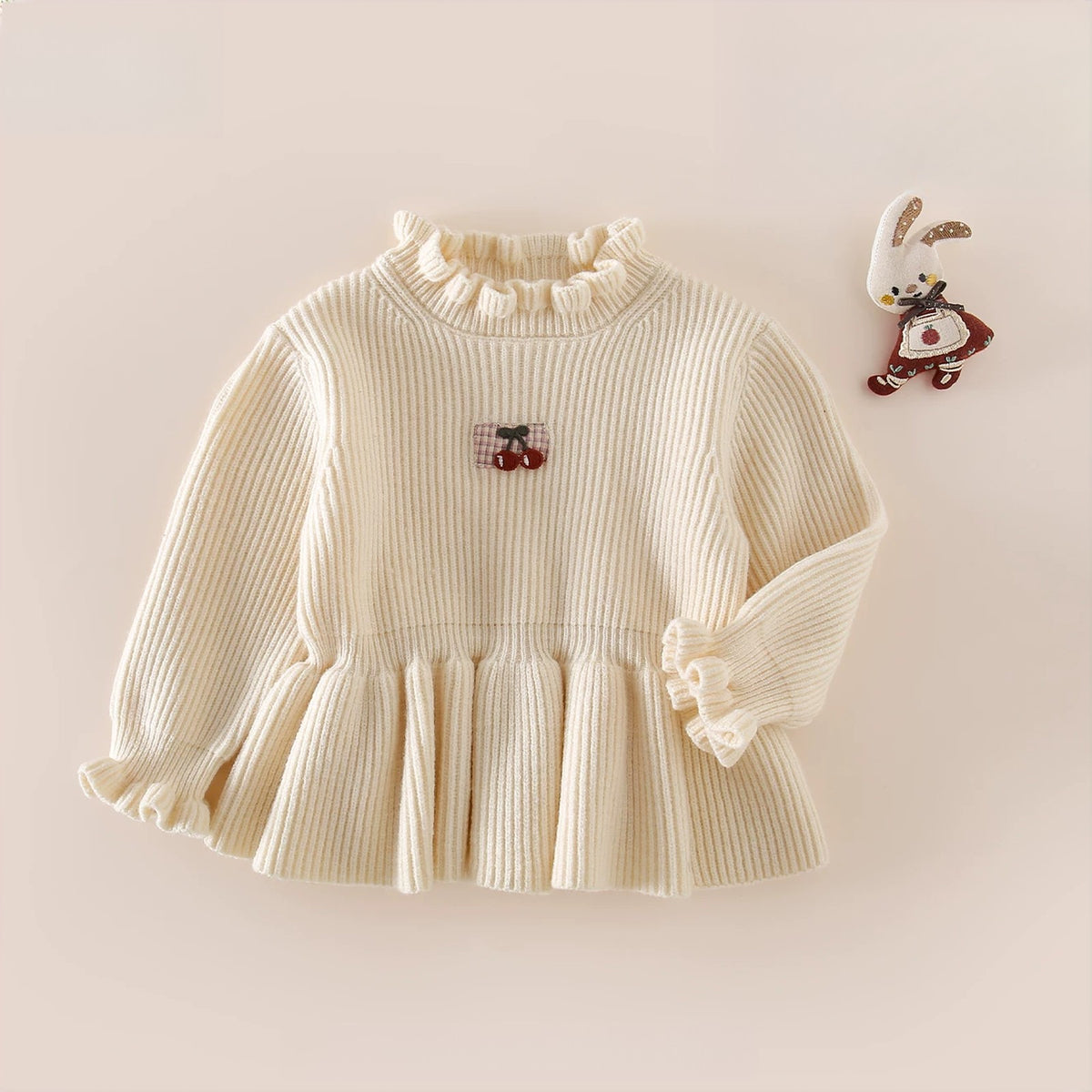 Cream ribbed knit peplum sweater with frilled neck and cherry patch