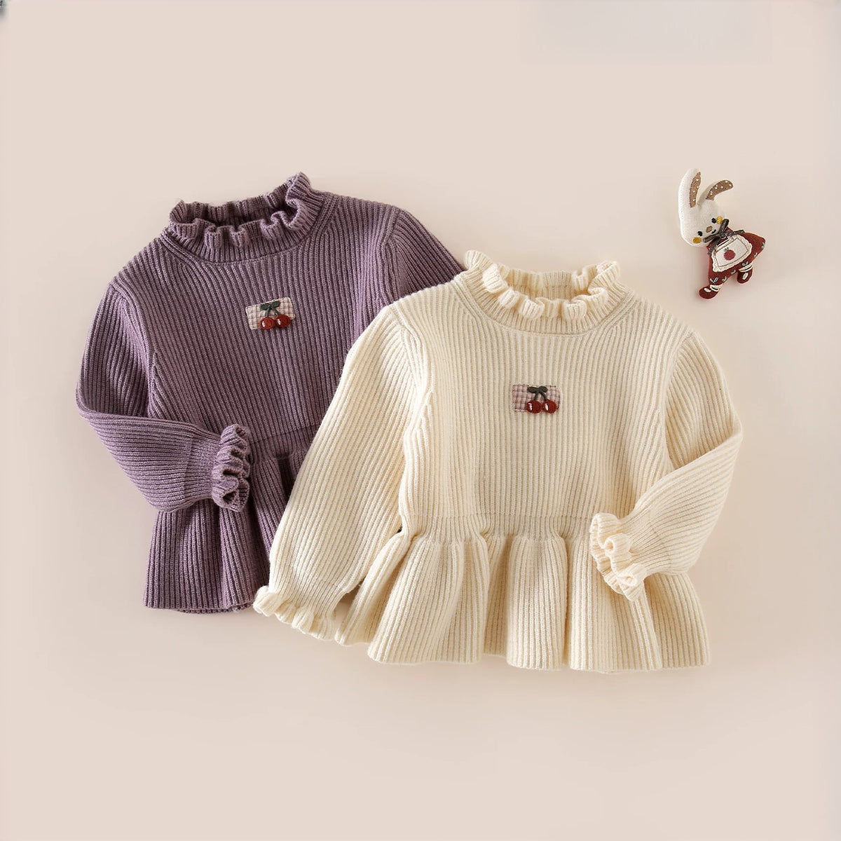 Cream and lilac cherry ruffle sweaters side by side