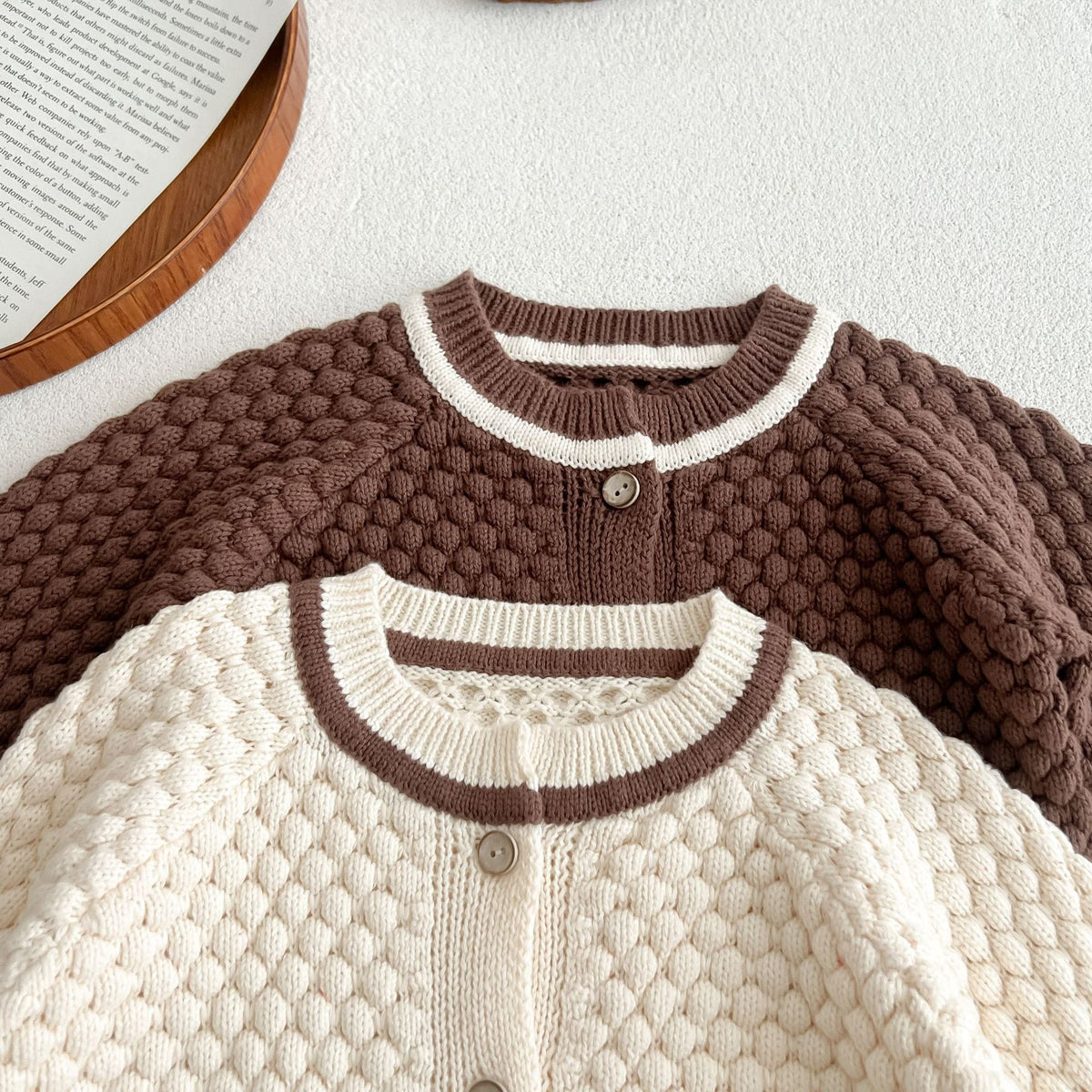 Close-up of the popcorn knit texture and contrast neckline