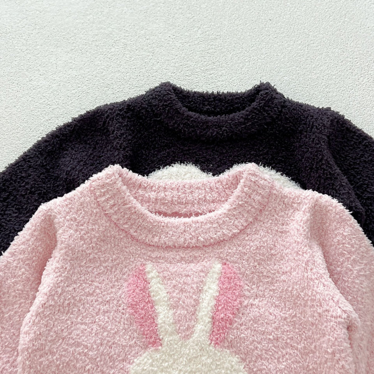 Close-up of the fuzzy knit texture and ribbed neckline