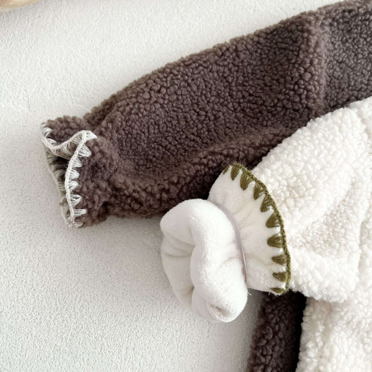 Close-up of cocoa and ivory sherpa sleeves with soft inner lining