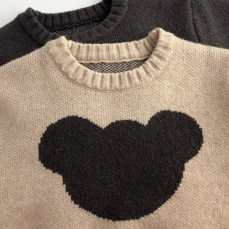 Close-up of the ribbed crew neck and bear motif on the oatmeal sweater