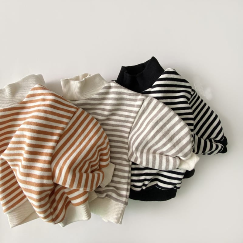 Three striped mock neck tops in pumpkin, grey and black, flat lay