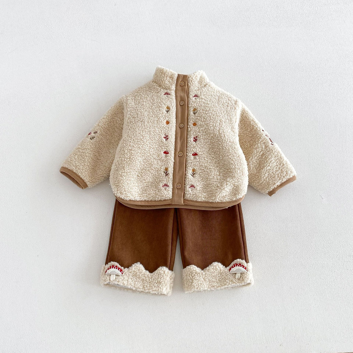 Oatmeal mushroom sherpa jacket styled with brown corduroy pants (sold separately)