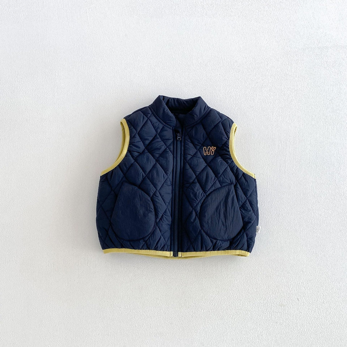 Navy quilted puffer vest with yellow trim, front view