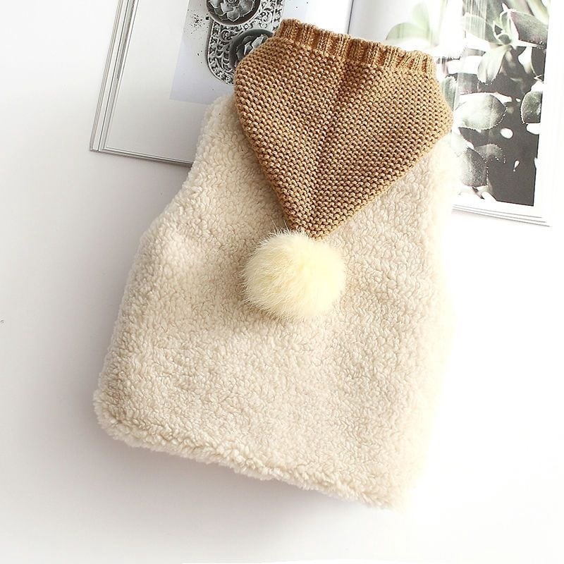 Cream sherpa vest with a tan knit pointed hood and pom-pom