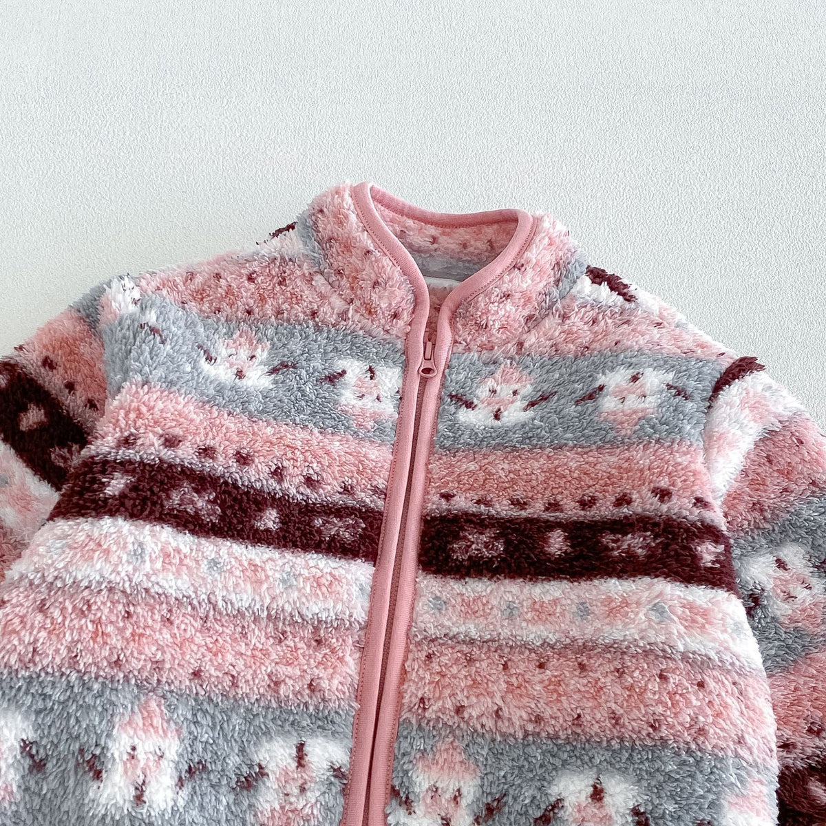Close-up of the stand collar, piping and zip on the rose jacket