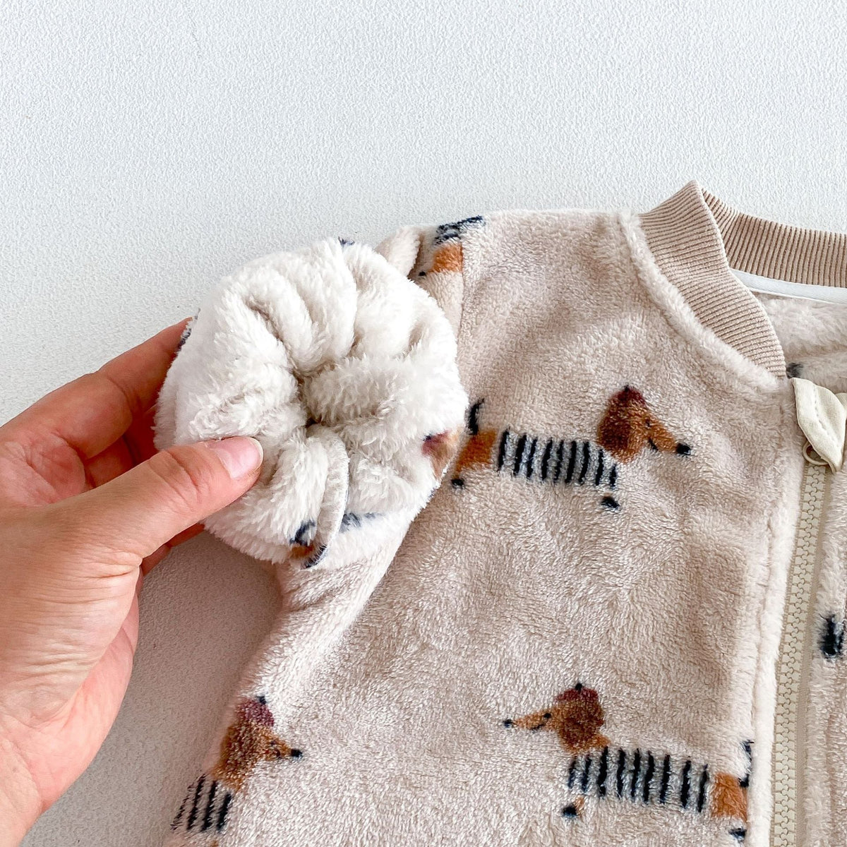 Plush lined sleeve of the dachshund fleece romper