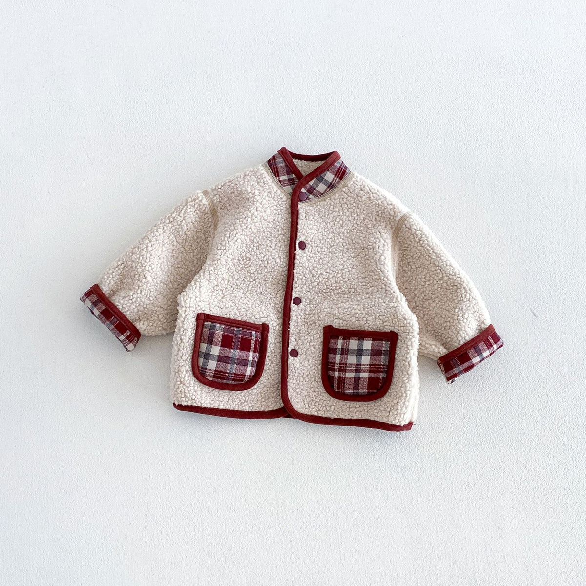 Cream sherpa side of the berry plaid reversible jacket with red trim