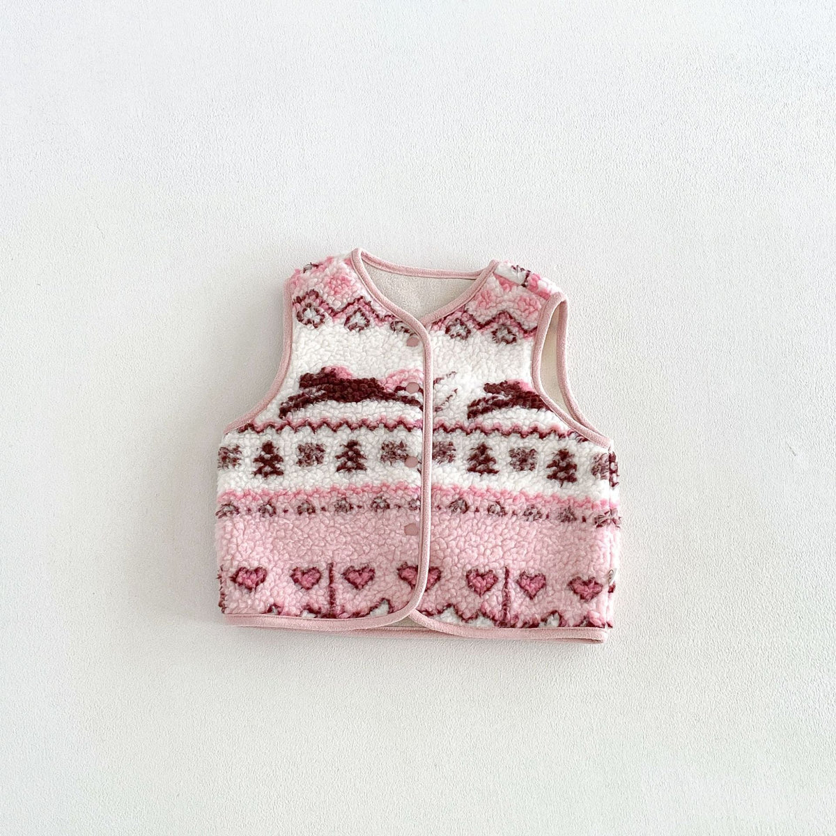 Pink fleece vest with bunny, heart and tree pattern, flat lay