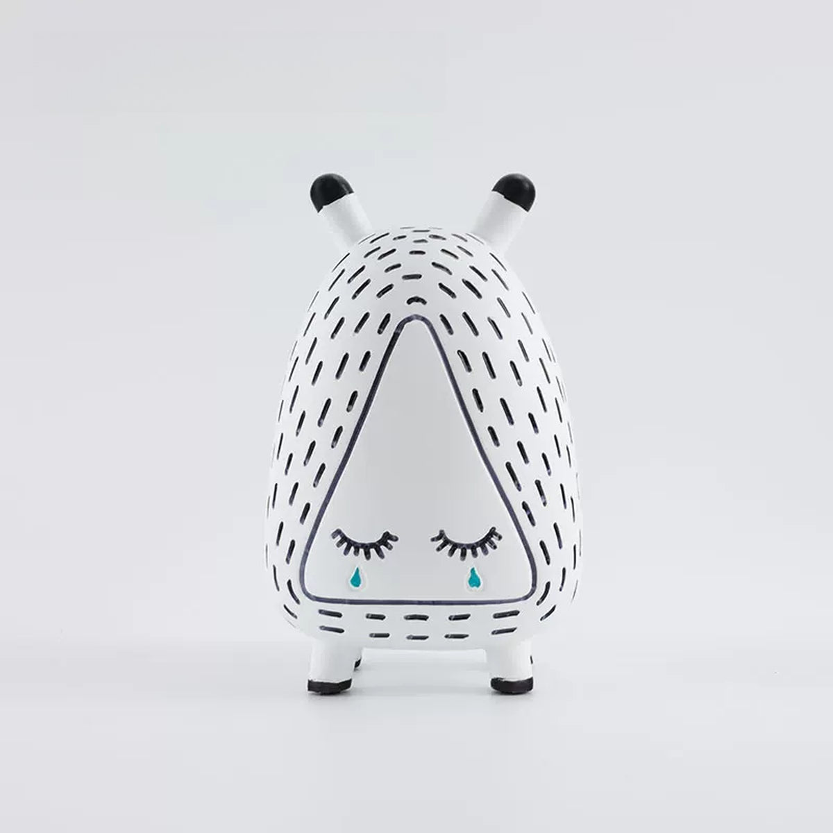 Sleepy Monster figurine with closed eyes and a single painted tear