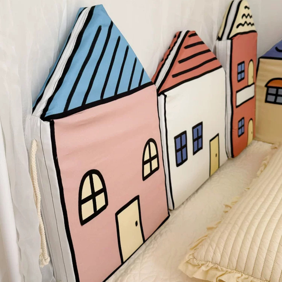 Close-up of a Crayon Town house cushion with piped edges