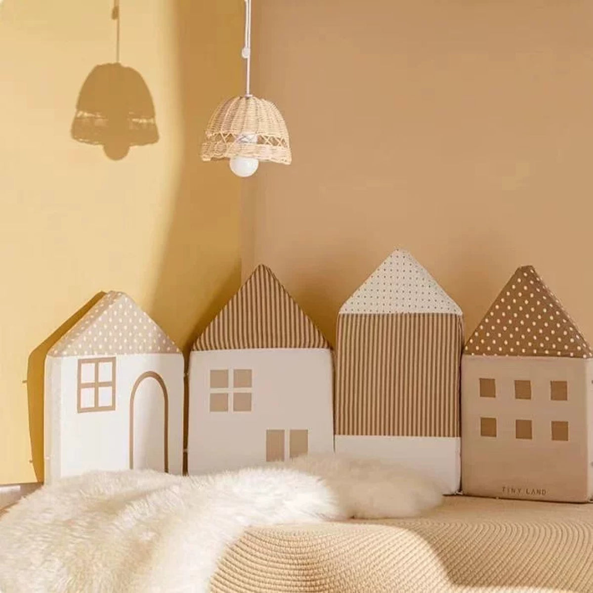 Mocha house cushions forming a cosy headboard in a warm nursery corner