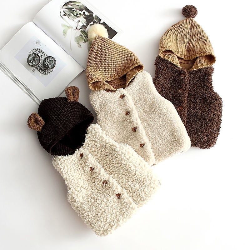 Three sherpa baby vests with knitted hoods in cream and cocoa