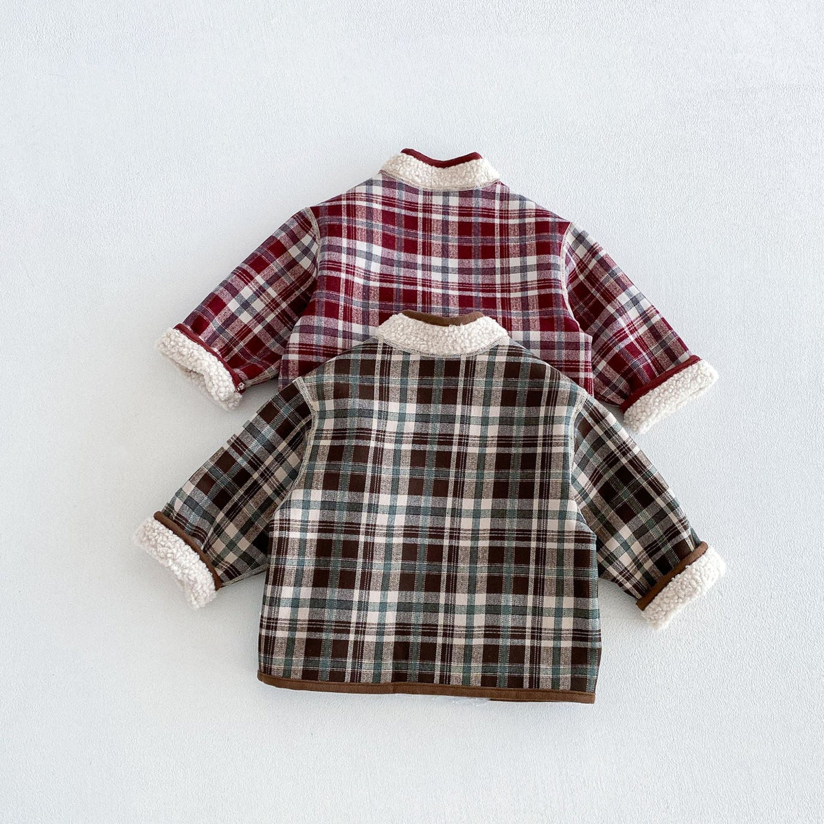 Back view of the berry and forest plaid jackets
