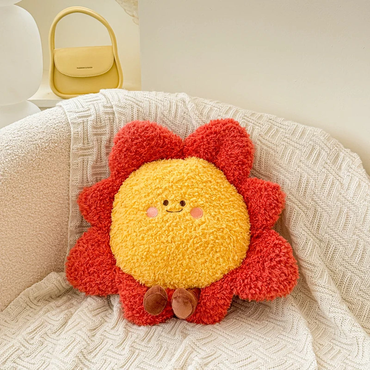 Sunshine plush cushion with red petals and a smiling face