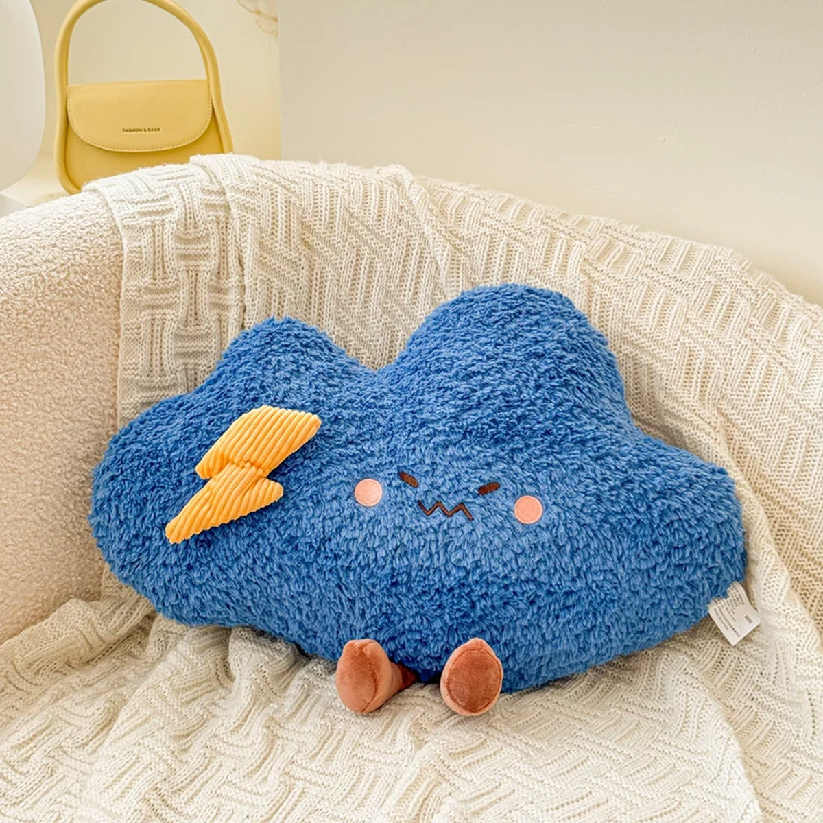 Blue storm cloud plush cushion with a lightning bolt