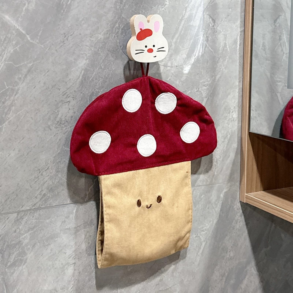 Mushroom tissue pouch hanging from a wooden bunny hook