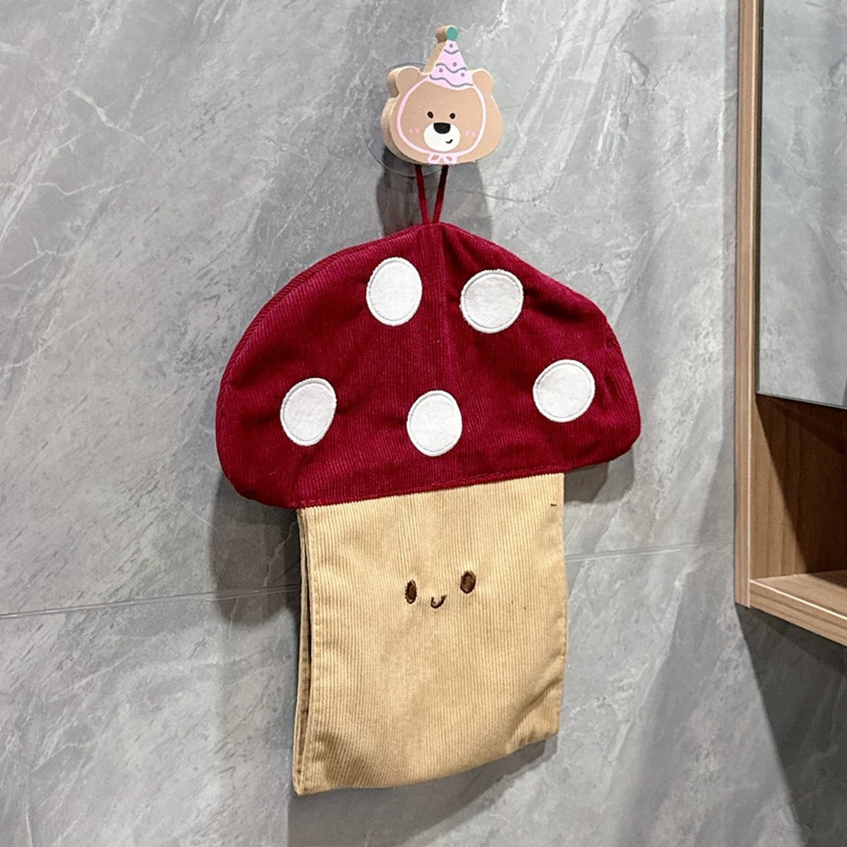 Mushroom tissue pouch hanging from a wooden bear hook