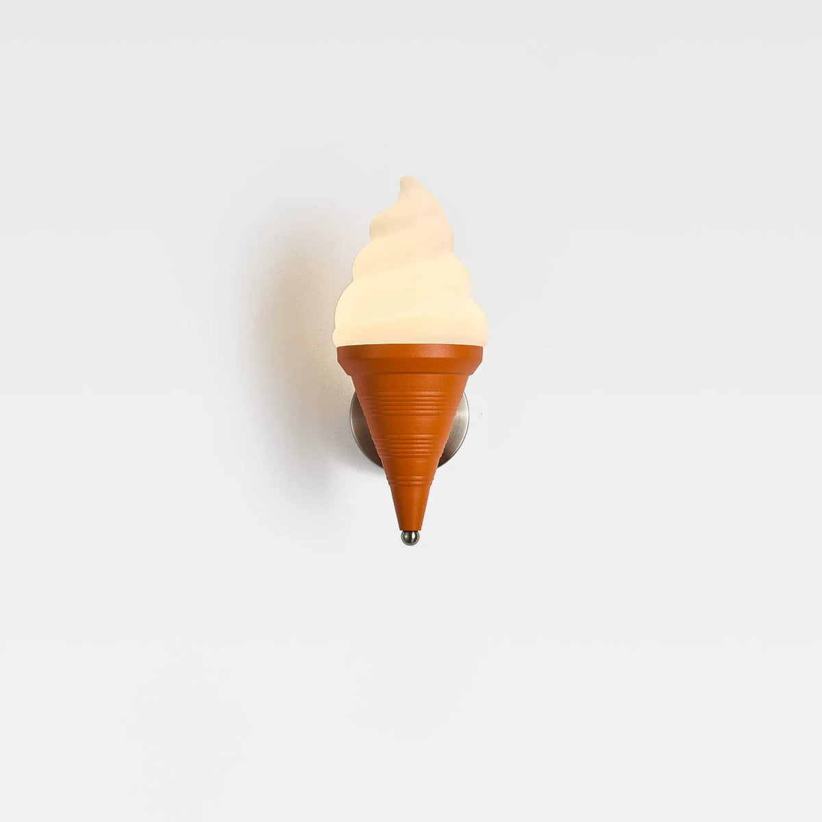 Ice cream wall lamp glowing warm white on a pale wall