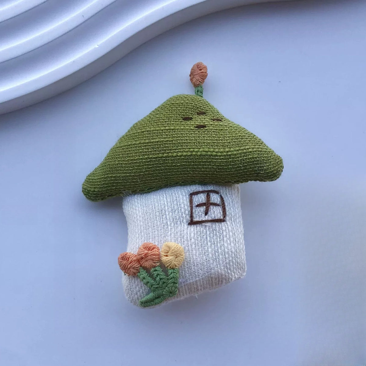 Little house fabric pin with olive green roof and embroidered flowers