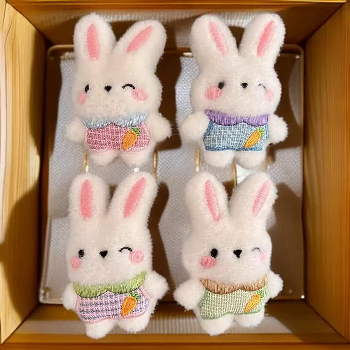 Four fluffy plush bunny charms in gingham outfits