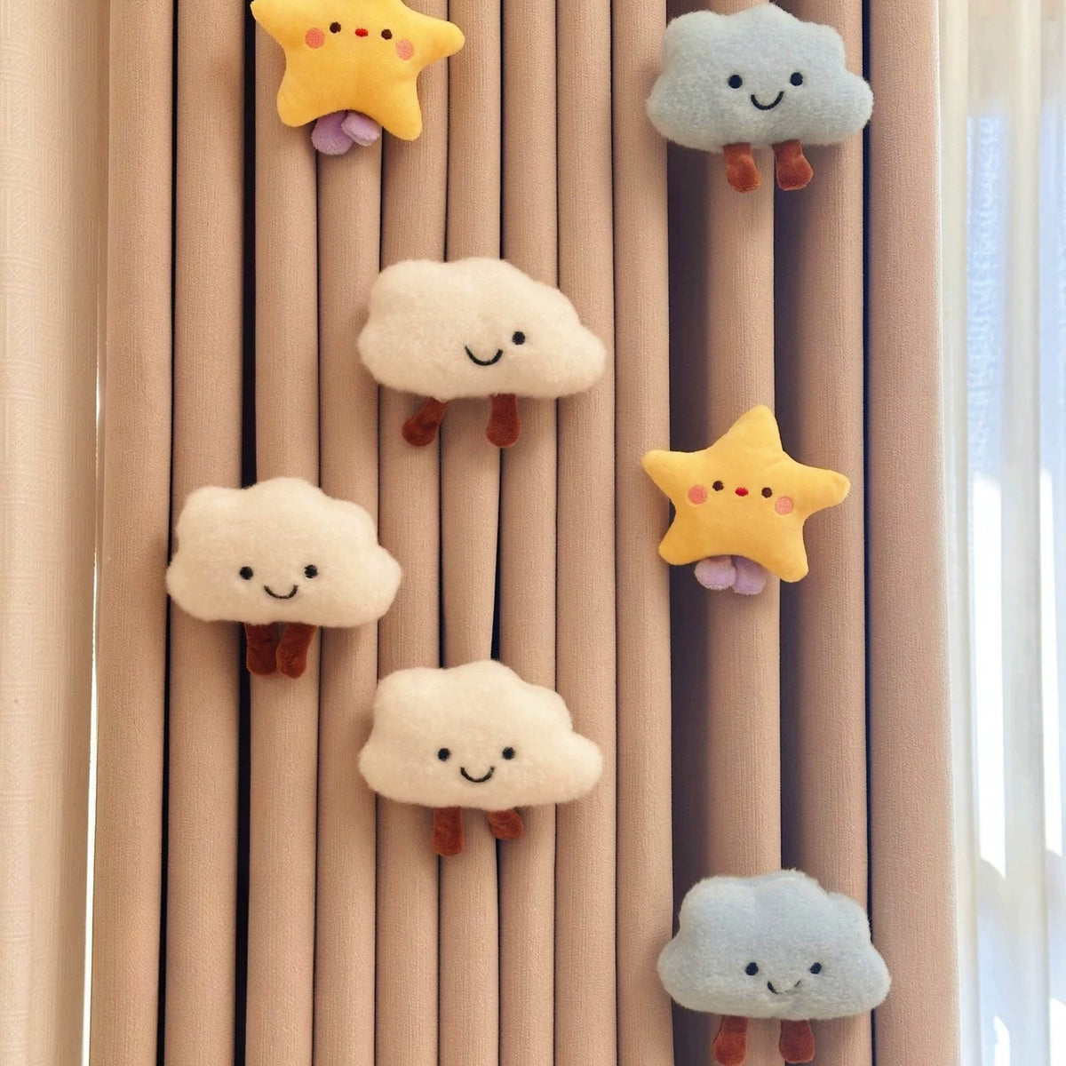 Plush clouds and stars decorating a nursery curtain