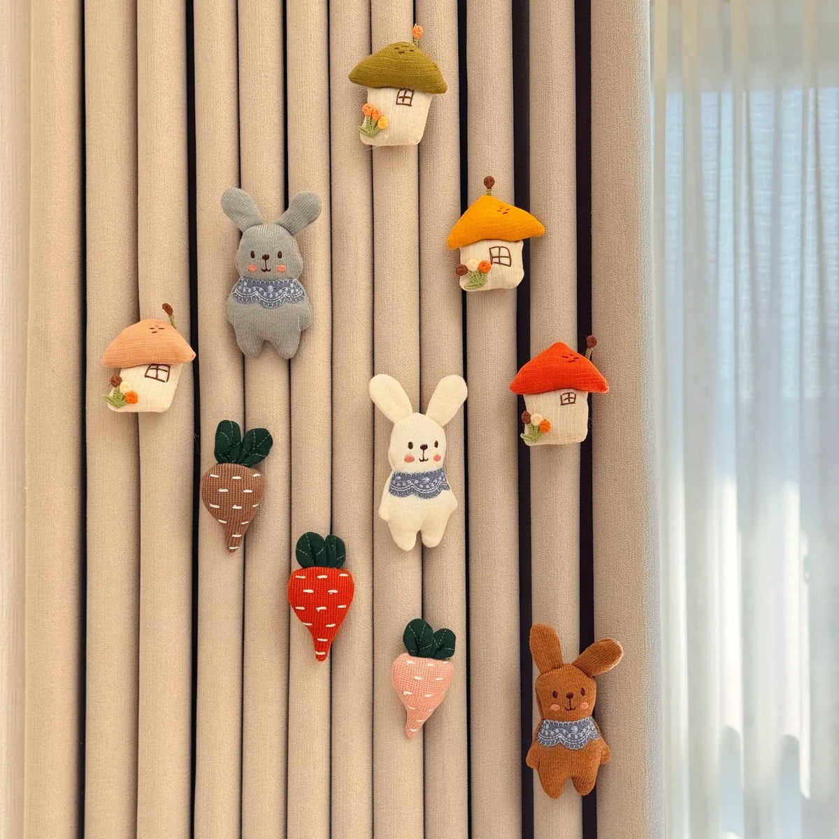Bunny Garden set: knitted bunnies, carrots and little houses pinned on a curtain