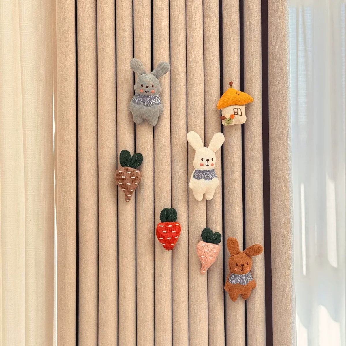Bunny Patch set: three knitted bunnies with carrots and a little house on a curtain