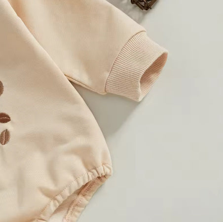 Tan baby bubble romper ribbed cuff and elastic hem detail