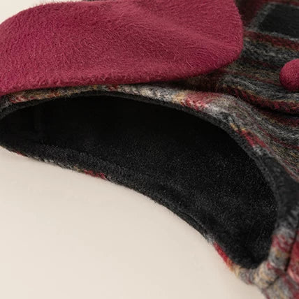 Close-up of burgundy collar and plush fleece lining on plaid dress