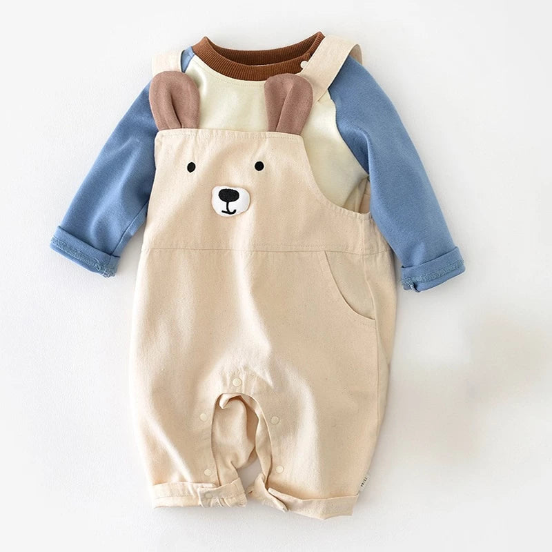 Bear face baby overalls layered over a cream and blue raglan tee, flat lay
