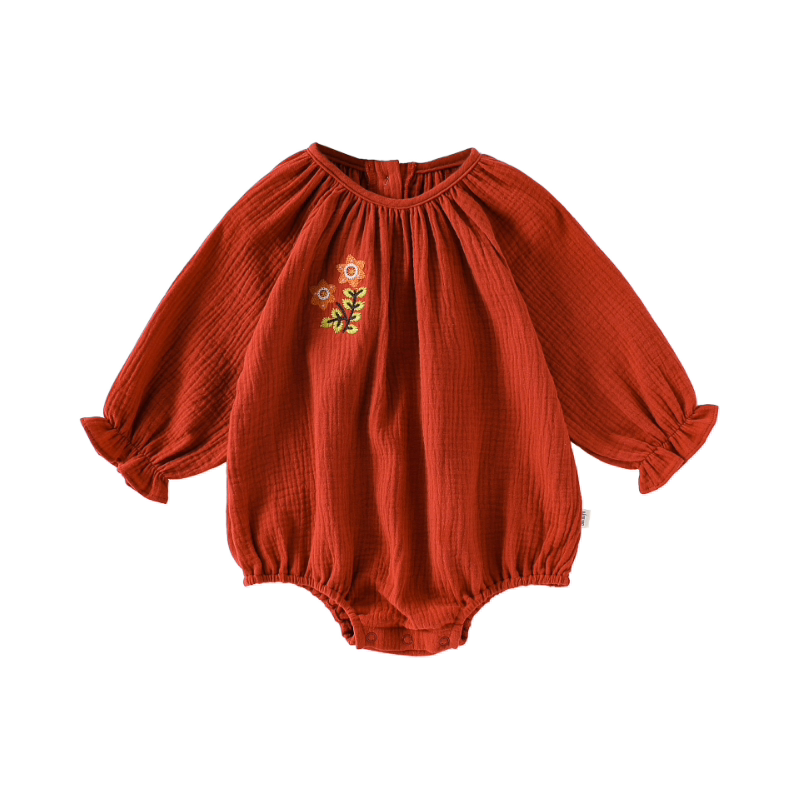 Brick red double gauze bubble romper with embroidered flower, flat lay