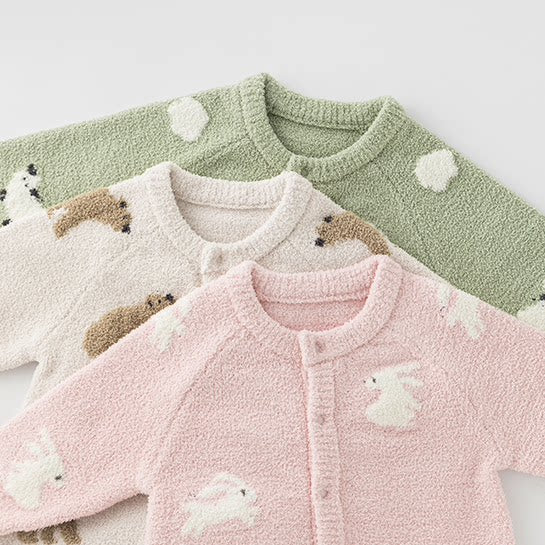 Matcha, oat and pink plush knit baby rompers stacked together
