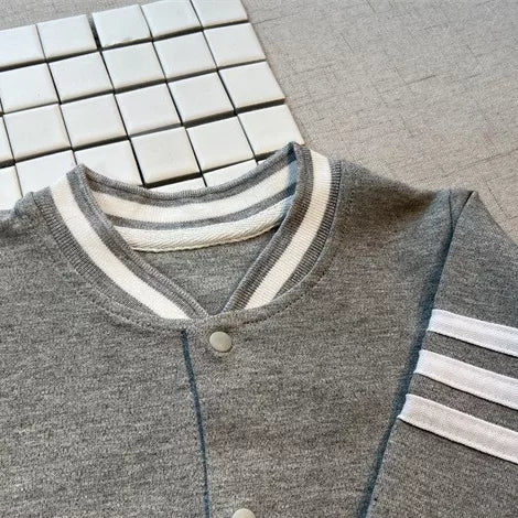 Detail of the triple sleeve stripe and ribbed collar on the grey romper