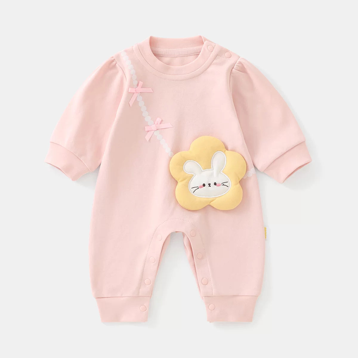 Blush pink cotton baby girl romper with padded flower bunny bag appliqué, flat lay