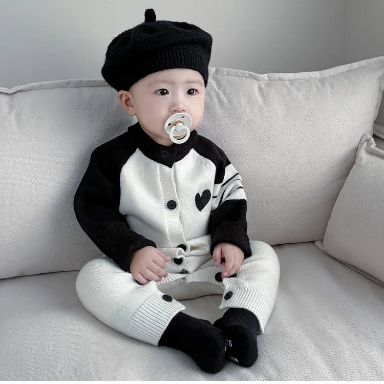 Black and cream knit romper with button front and buttoned legs