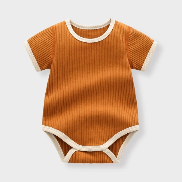 Caramel ribbed baby bodysuit with cream contrast trim, flat lay