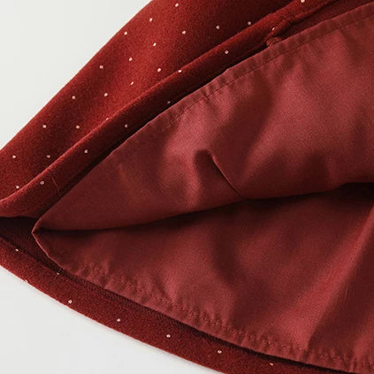 Lined skirt hem of red dotted pinafore dress