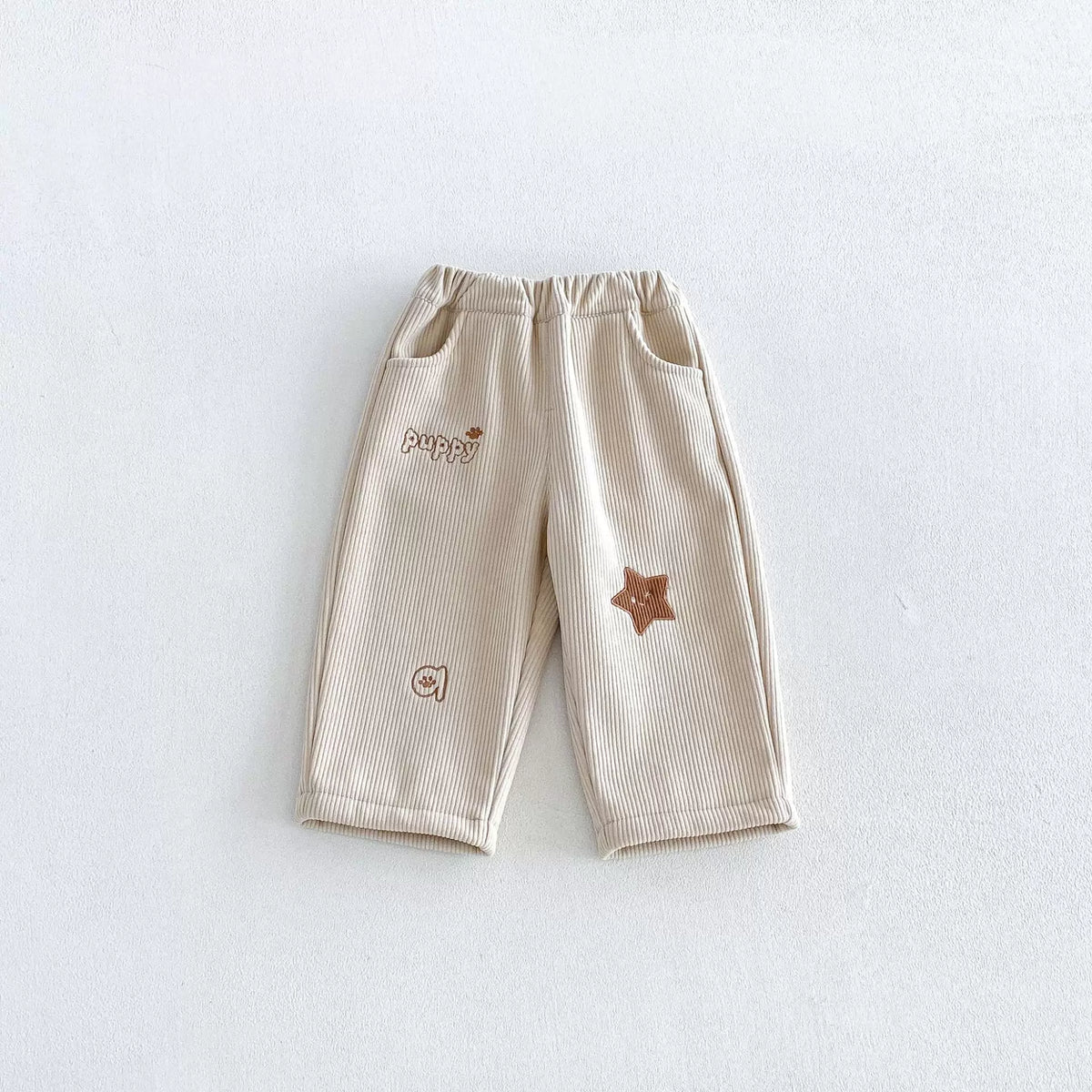 Almond cream fleece-lined corduroy pants with brown star patch
