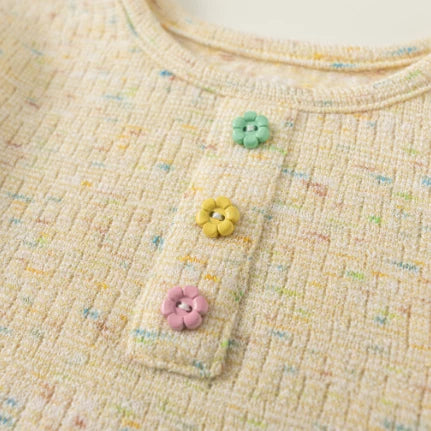 Close-up of the pastel flower buttons on the placket