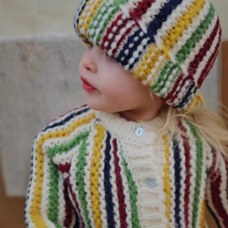 Close-up of the cream ribbed collar and pearly buttons on a striped knit cardigan
