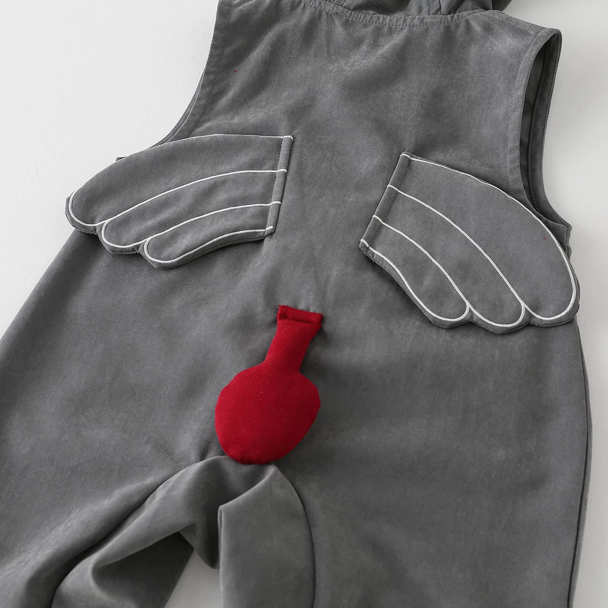 Detail of the little wings and red tail on the back of the baby romper