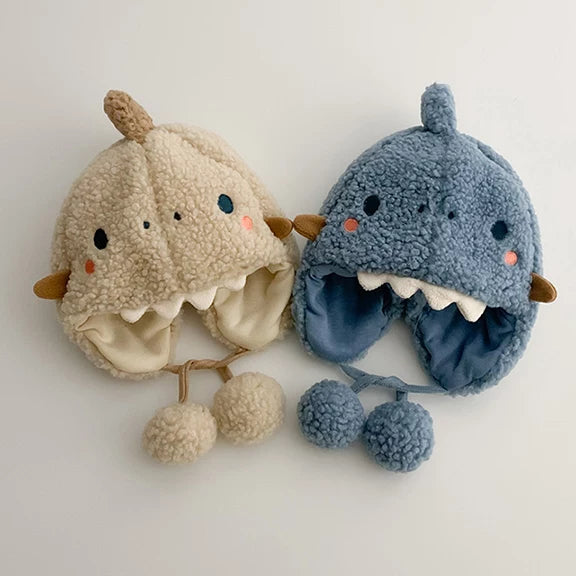 Oat and denim blue dino hats showing the soft fleece lining