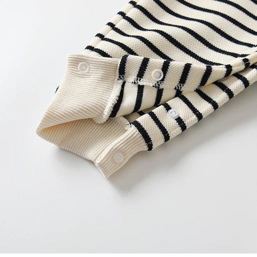 Snap-button legs and ribbed ankle cuffs on the striped baby romper