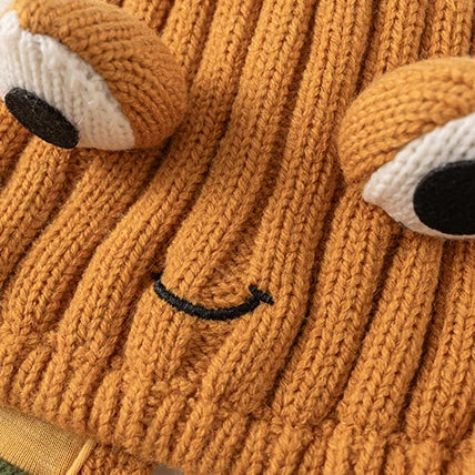 Close-up of the knitted frog eyes and embroidered smile